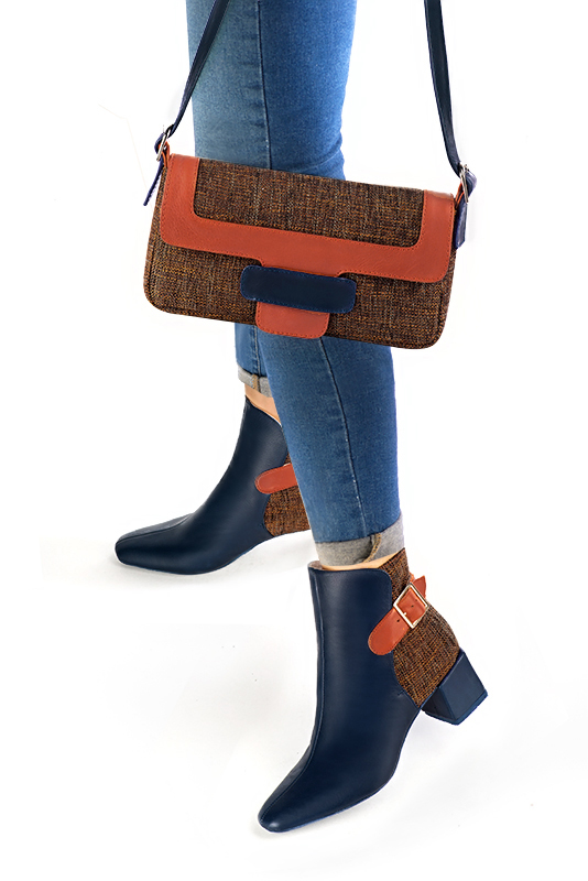 Women's navy blue and terracotta orange elegant ankle boots, with buckles at the back. Square toe. Medium block heels - Worn view